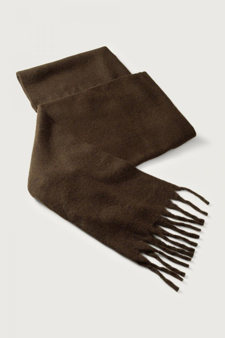 Brown scarf with fringes on a light gray background