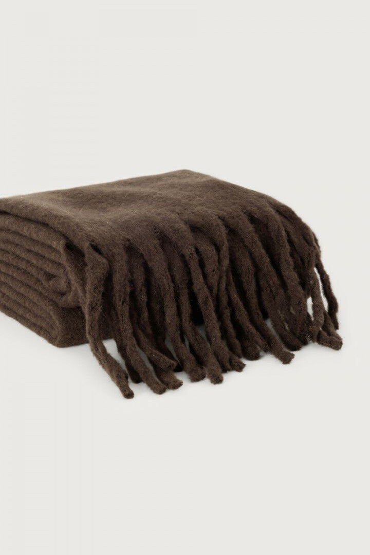 Brown scarf with fringes on a light gray background
