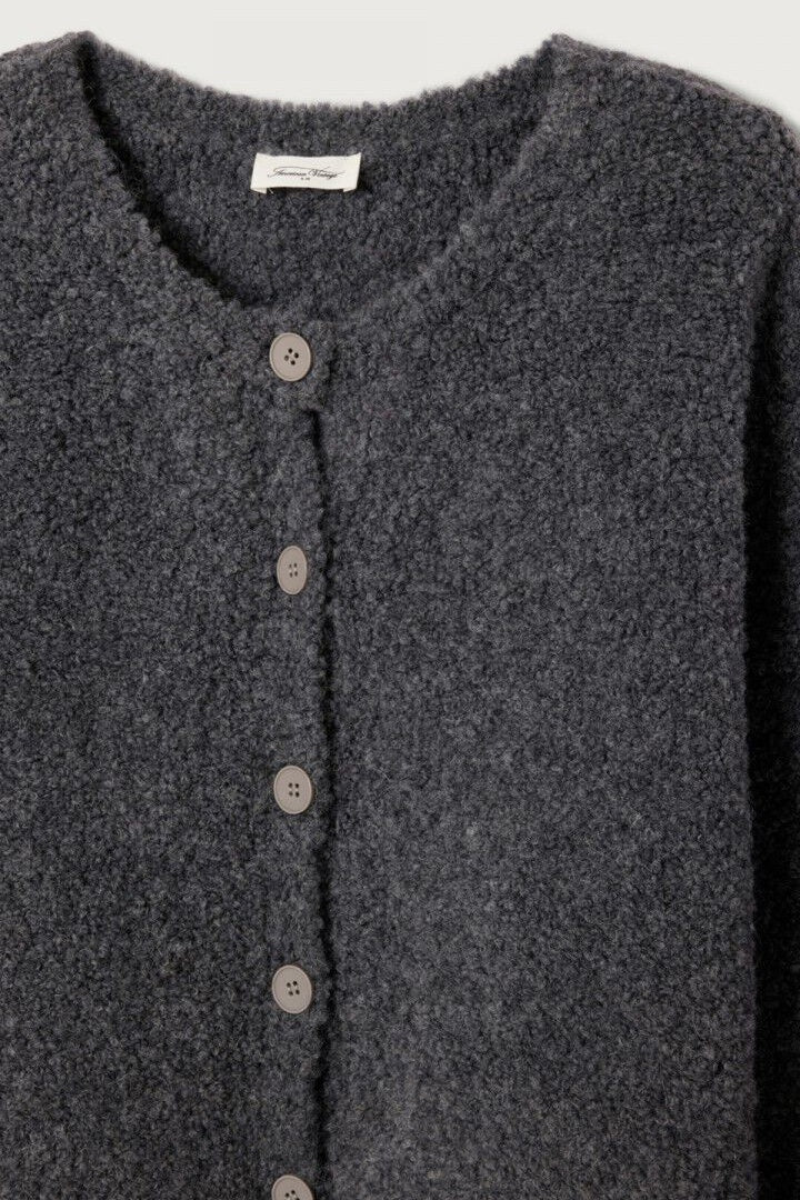 Dark grey cardigan with button details on a light gray background
