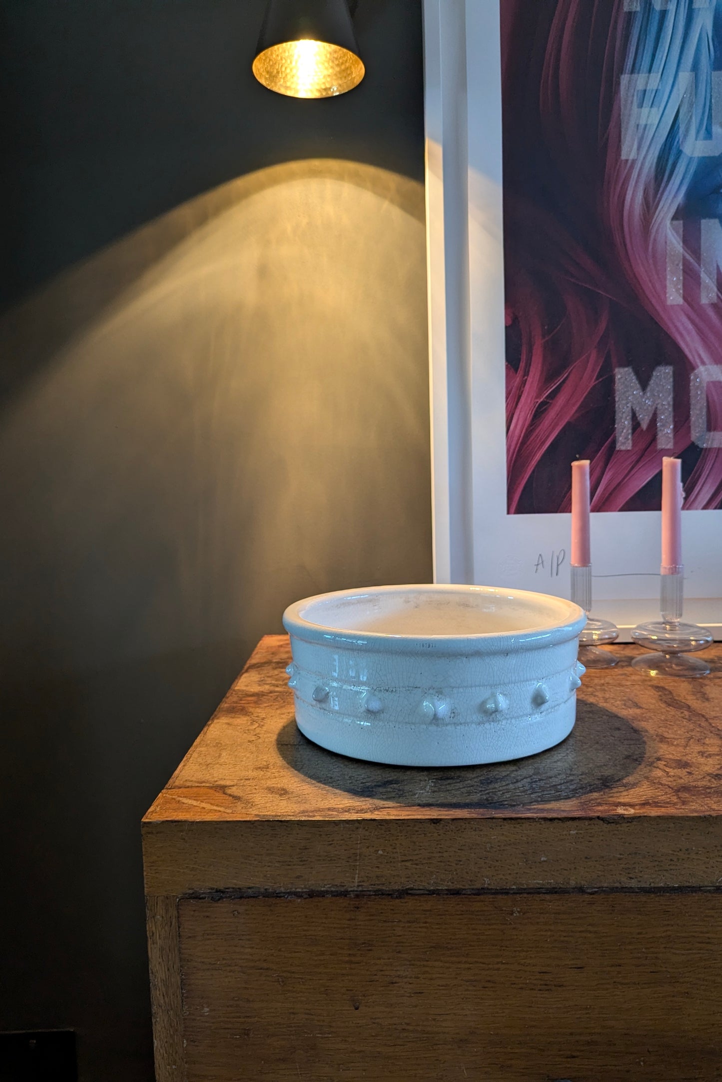 White ceramic bowl on a wooden surface with a dark background