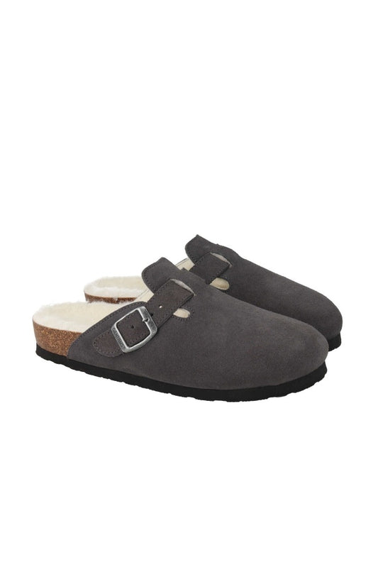 Pair of grey suede clogs with a buckle on a white background