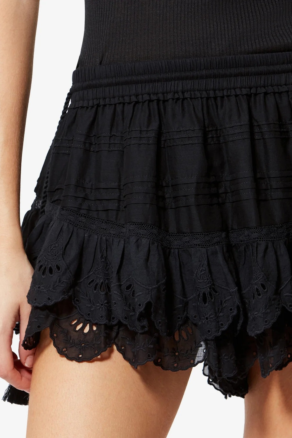 Black ruffled shorts with scalloped hem on a white background