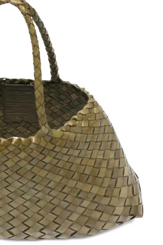 Woven handbag with braided handle on a white background