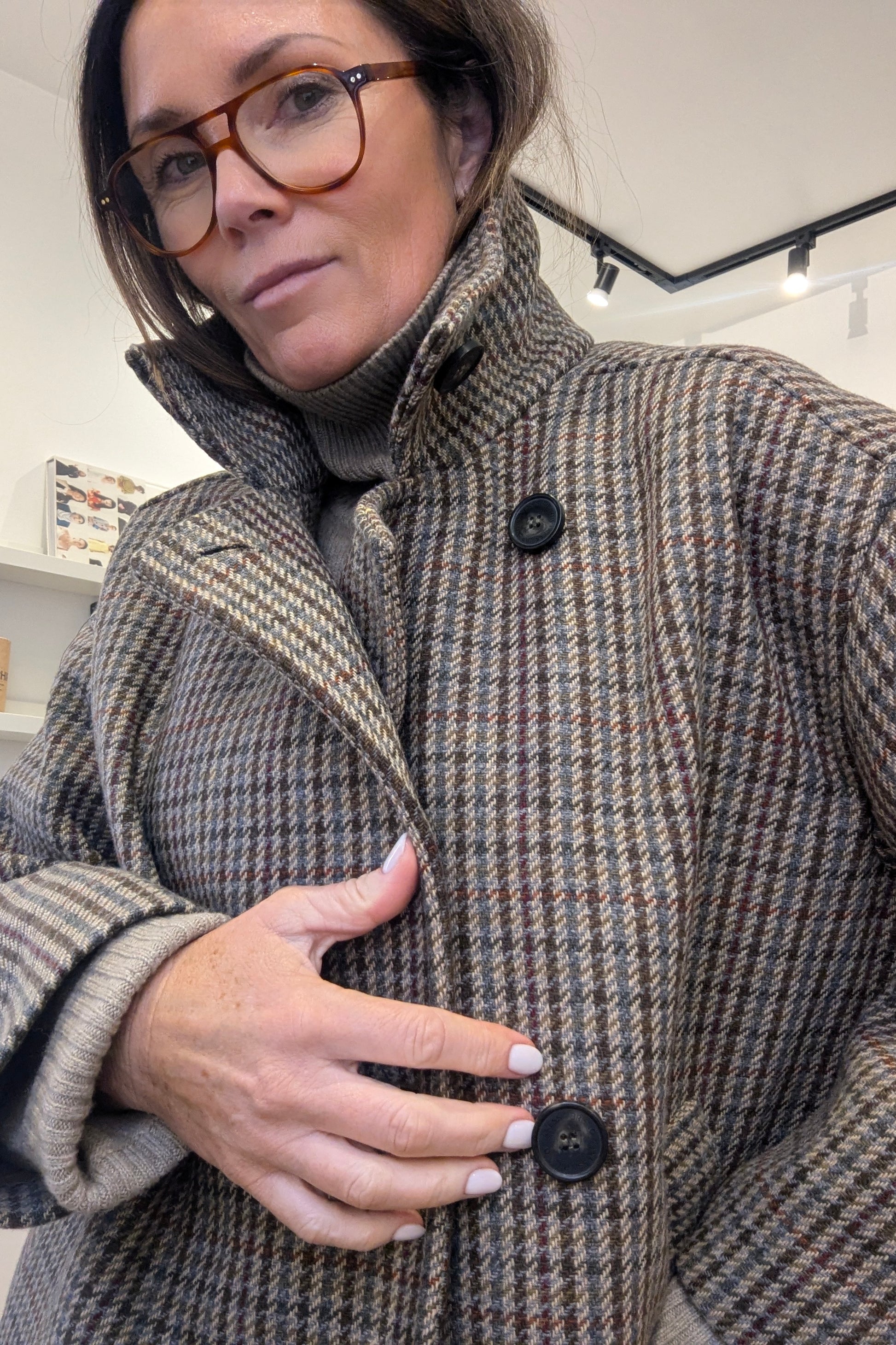 Person wearing a Vanessa Bruno patterned coat with a neutral background