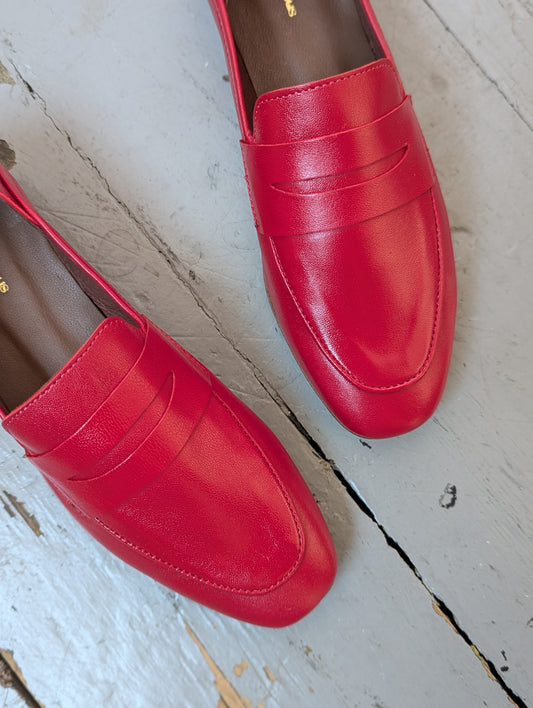 Anonymous Copenhagen Red leather loafers on grey floorboards