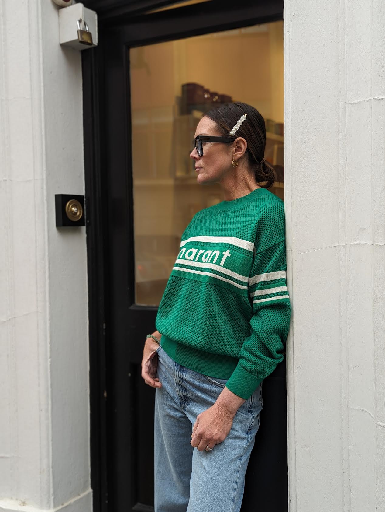 Zoie wearing Marant Étoile Arwen Emerald Open-Knit Sweatshirt outside of 32 The Guild