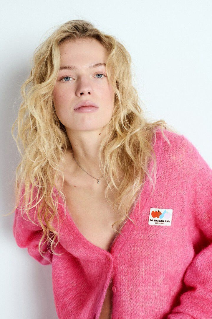 model wearing pink cardigan