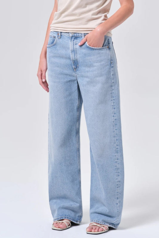 Light blue jeans worn by a person on a white background