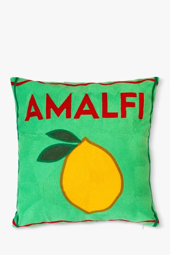 Green pillow with a lemon and 'AMALFI' text on a white background
