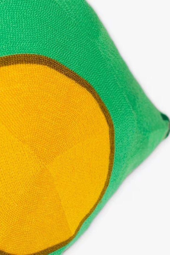 Green and yellow fabric square on a white background