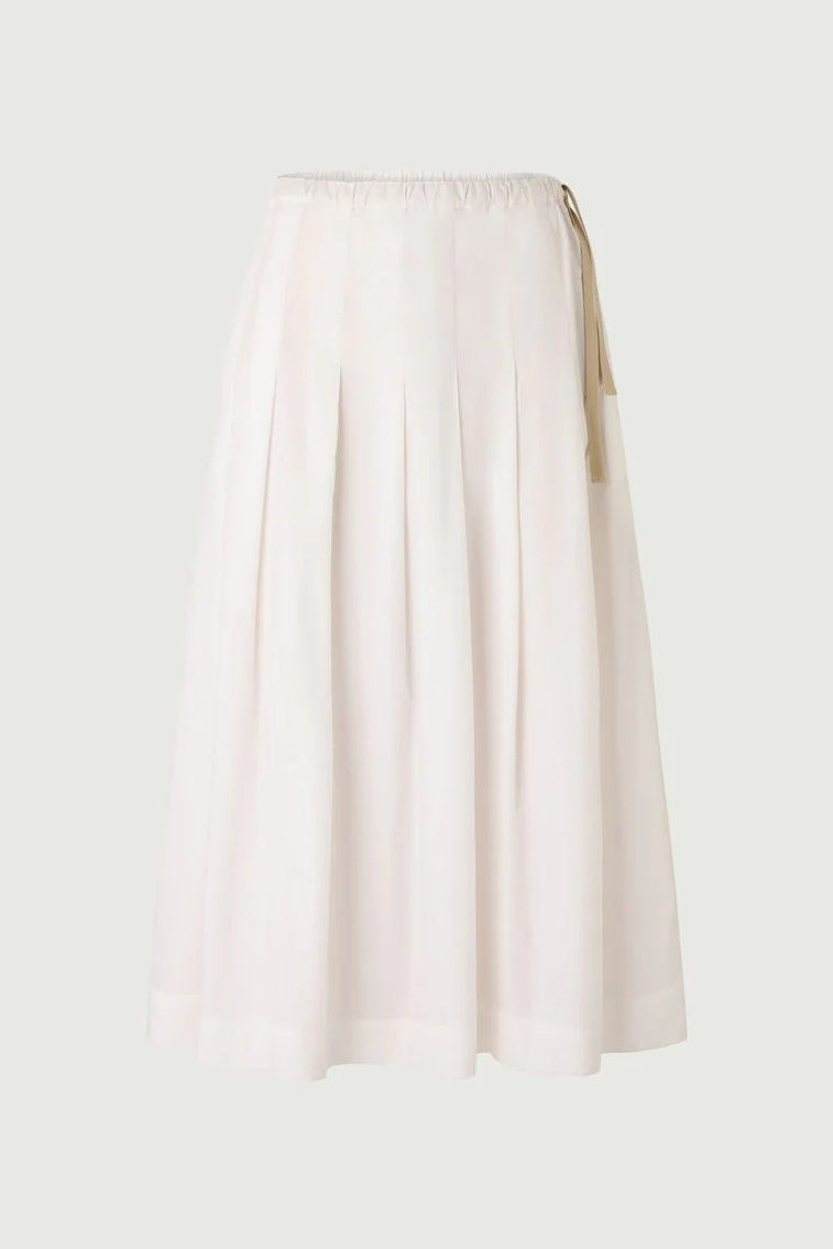 white skirt with cream tie detail on pale background