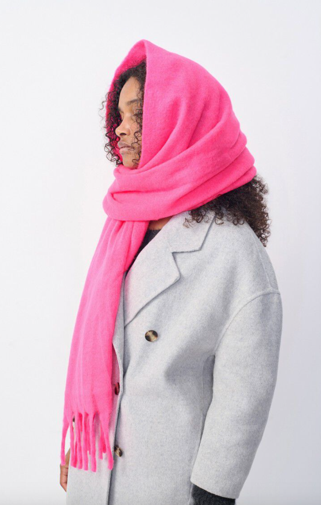 Model wearing a neon pink scarf on head