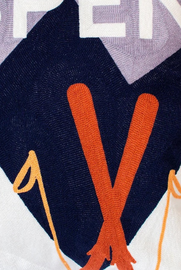 Close-up of a  SKI  EMBROIDERED ON A dark blue background
