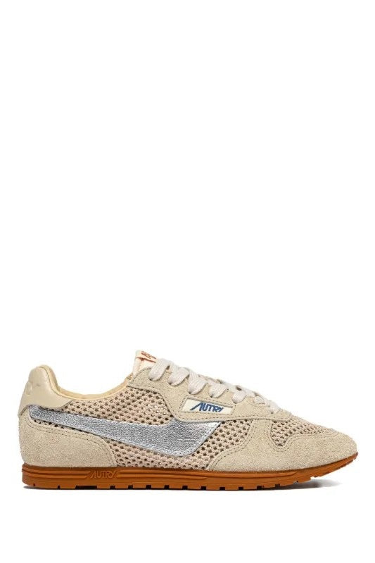 Beige sneaker with brown sole on a white background