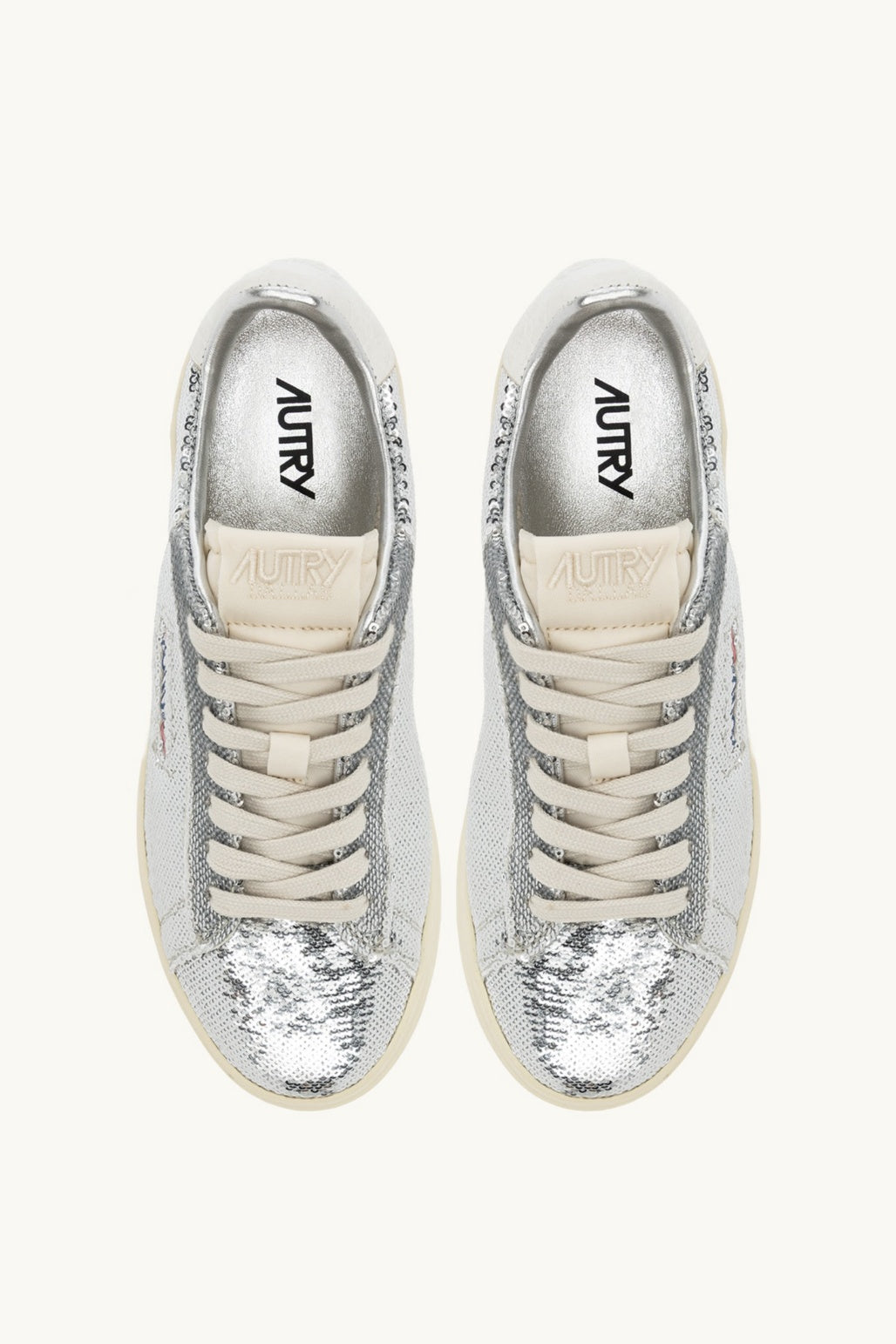 Pair of Autry silver sneakers with white soles on a white background