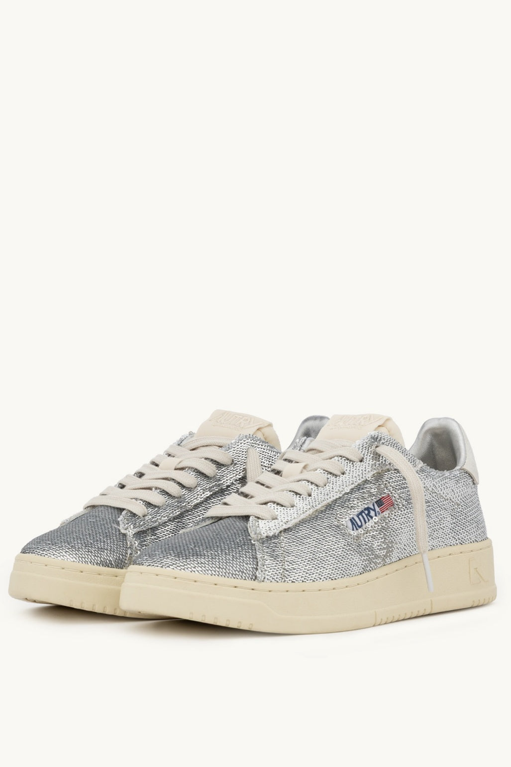 Pair of silver Autry sneakers on a white background