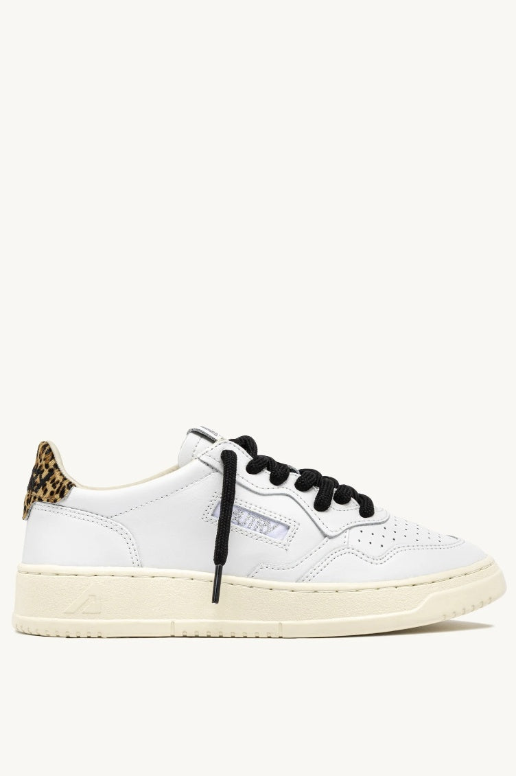 White sneaker with black laces and leopard print accents on a white background
