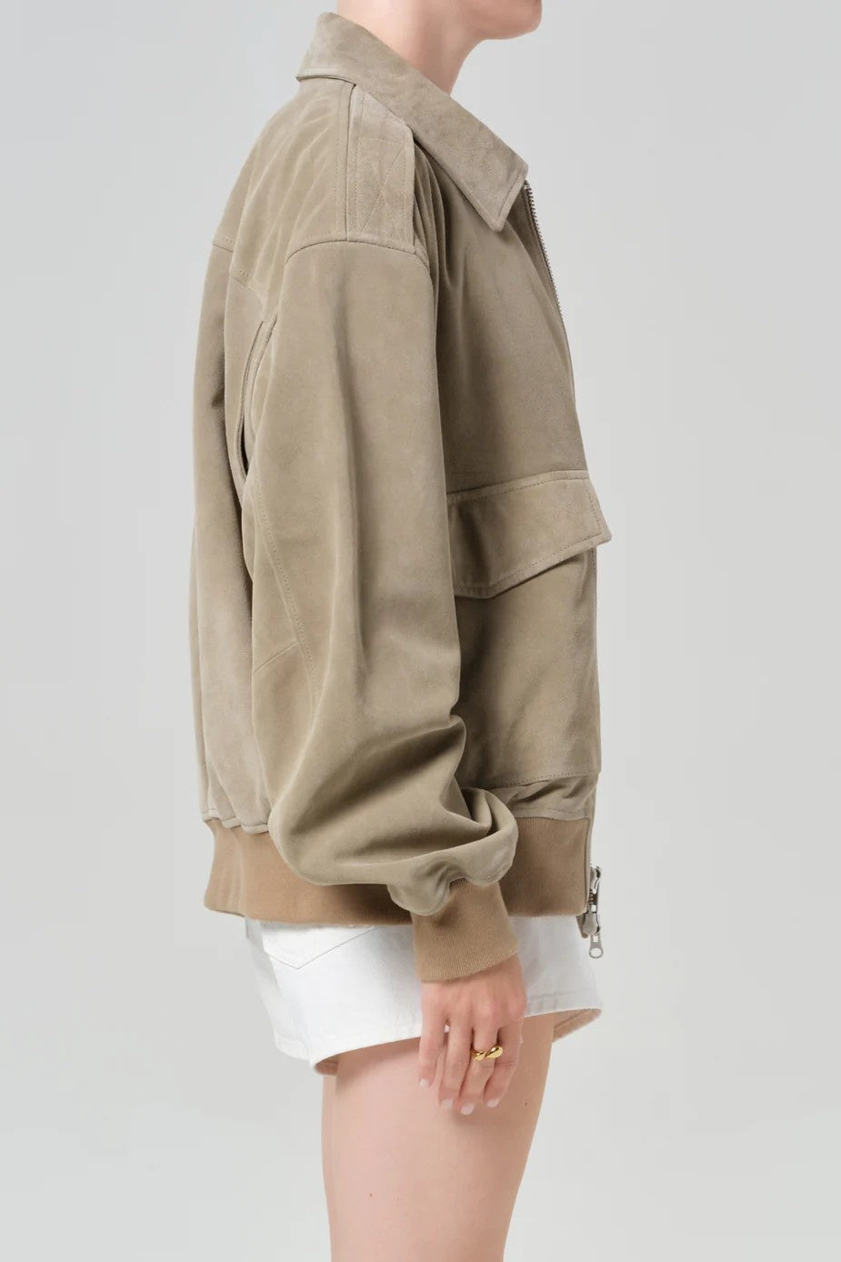 Beige jacket worn by a person on a plain background