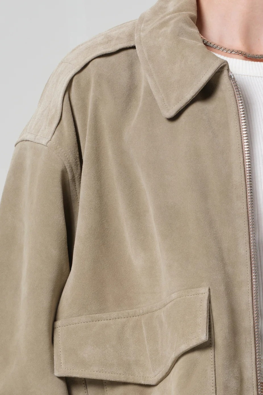 Close-up of a beige jacket with a neutral background