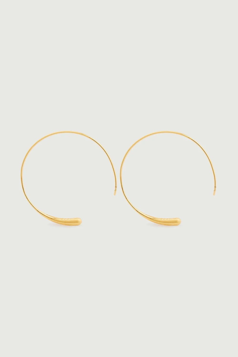 gold hoop earrings on white bakground