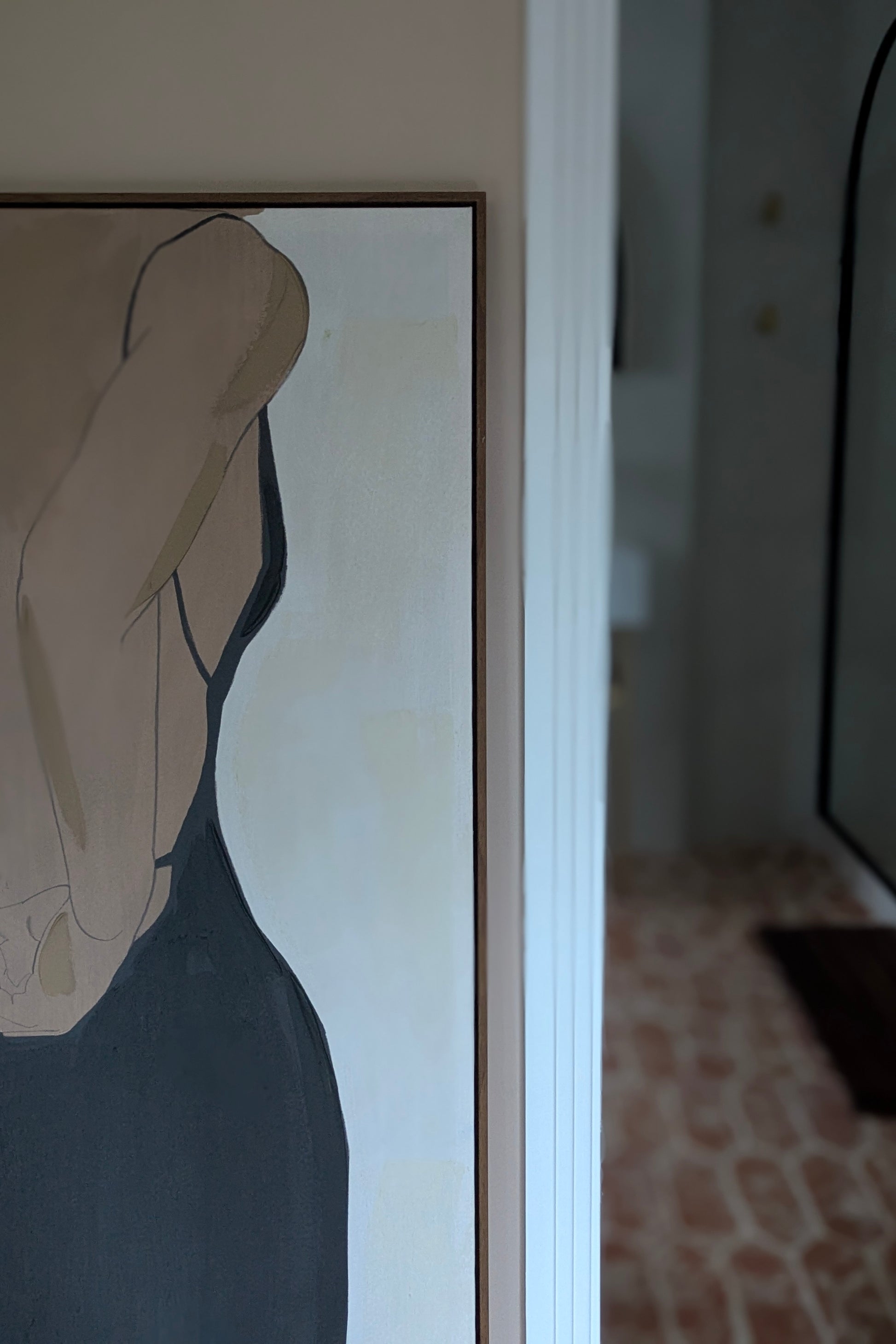 Abstract art piece with a neutral color palette on a wall.