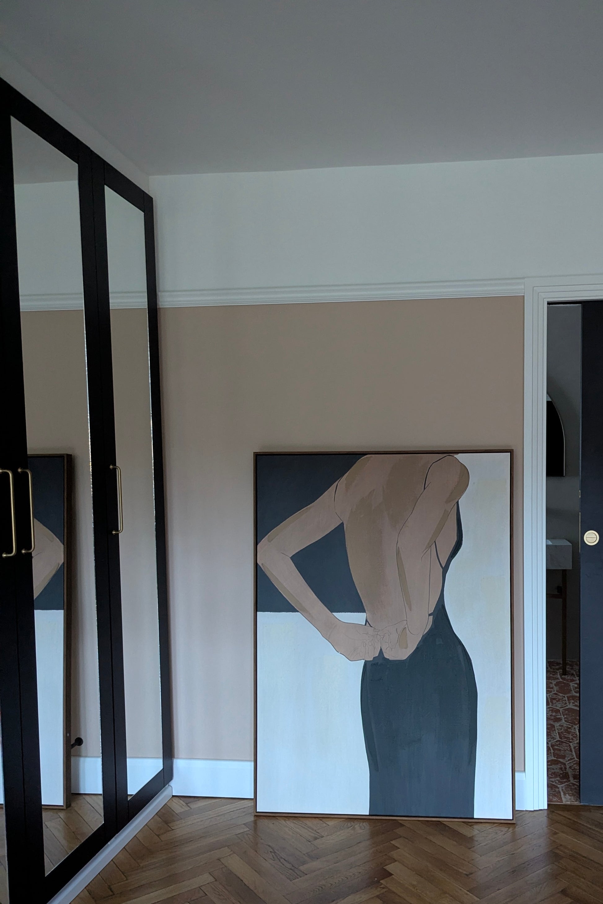 Modern interior with a large abstract painting of a woman on a wall.