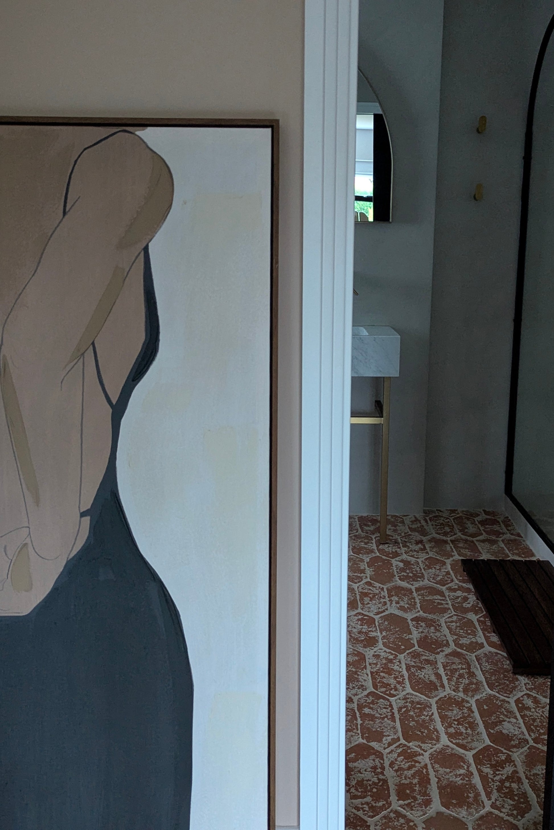 Abstract art piece on a wall with a room in the background