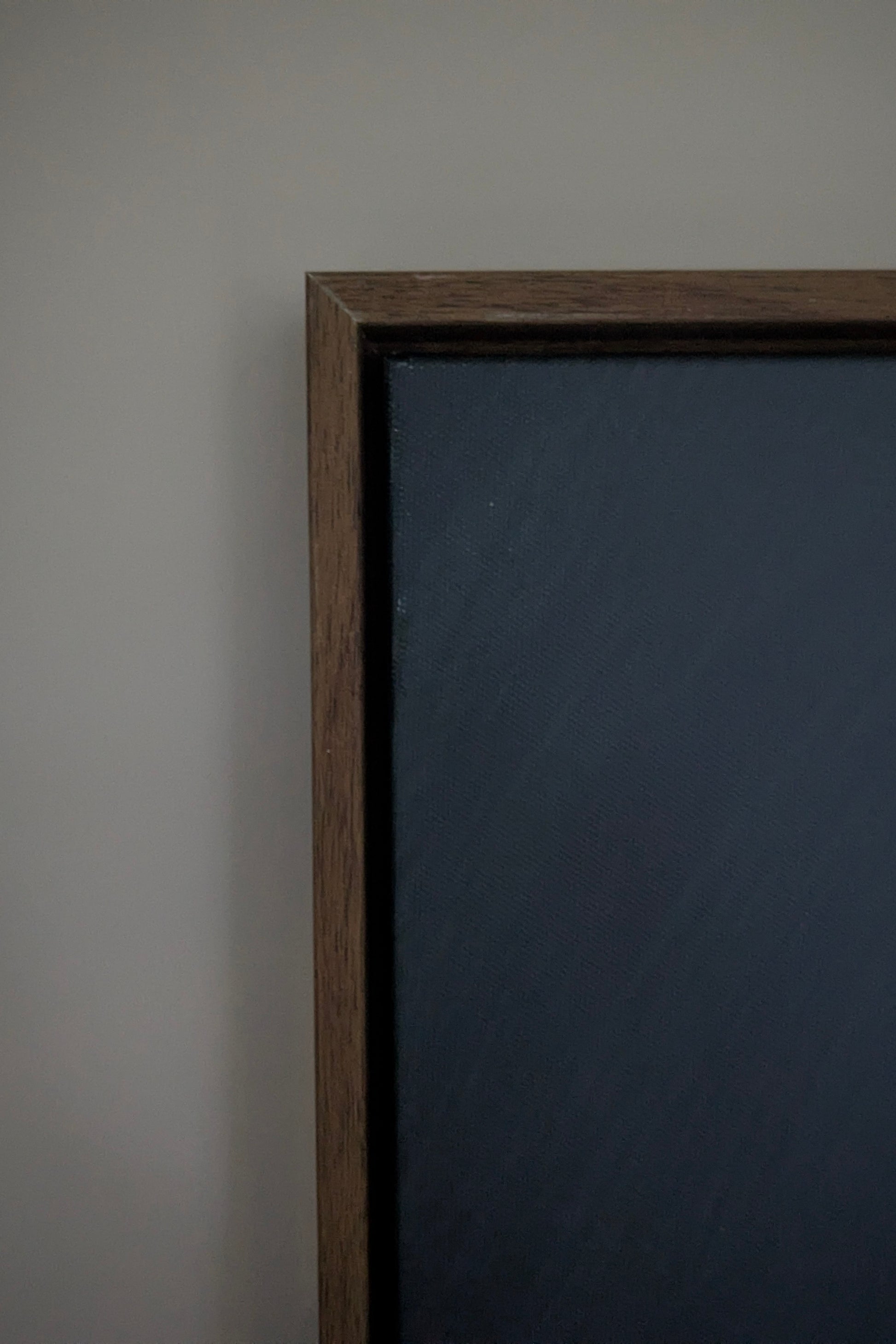 Dark wooden frame on a gray wall