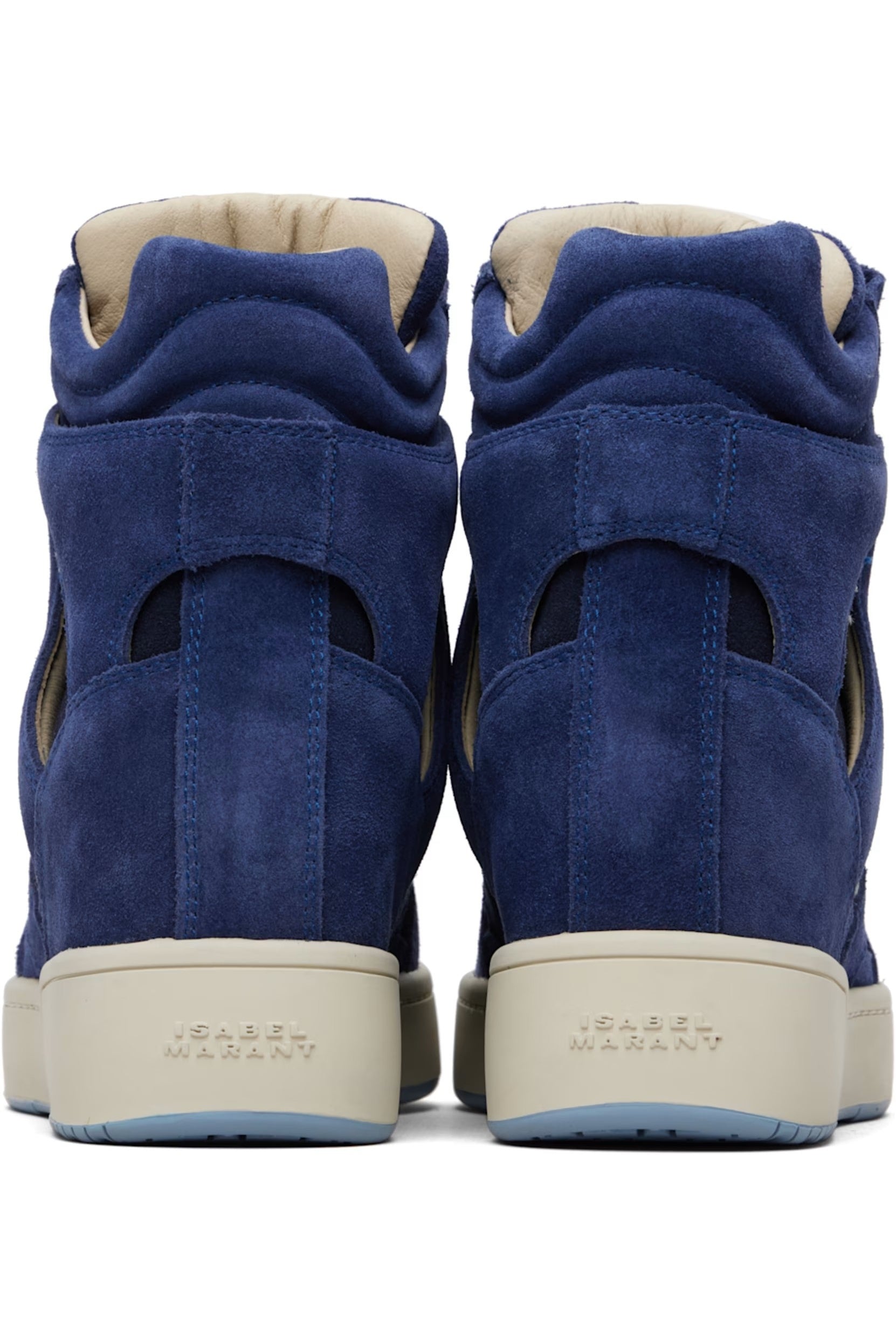 Pair of blue suede high-top sneakers with beige soles on a white background
