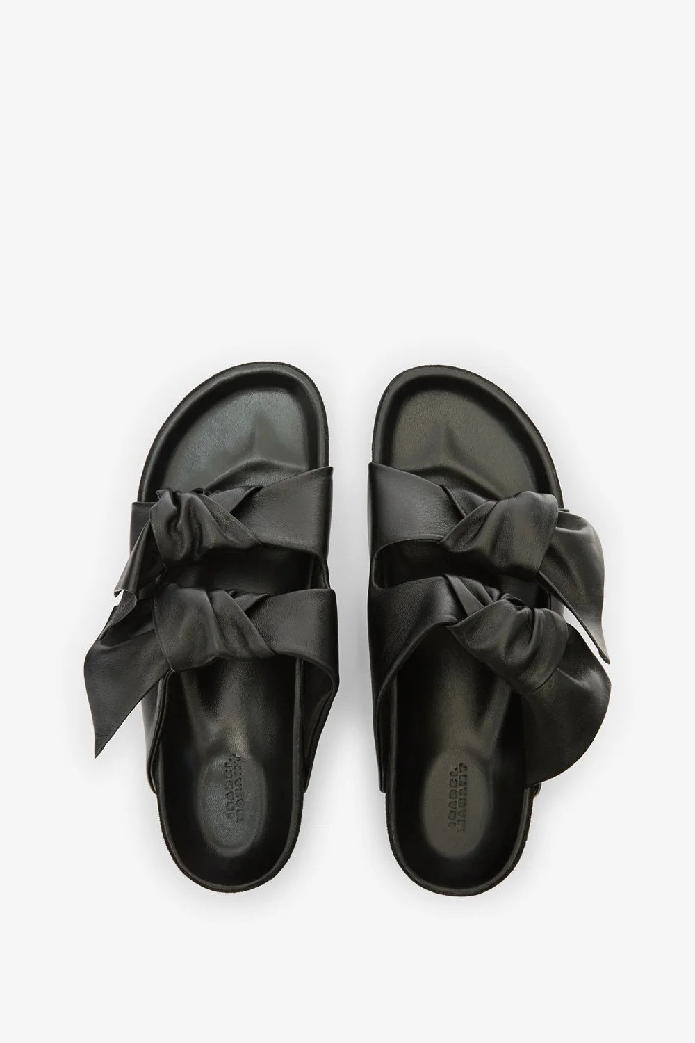 Black sandals with bow details on a white background