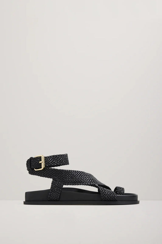 Black woven sandal with a gold buckle on a light gray background