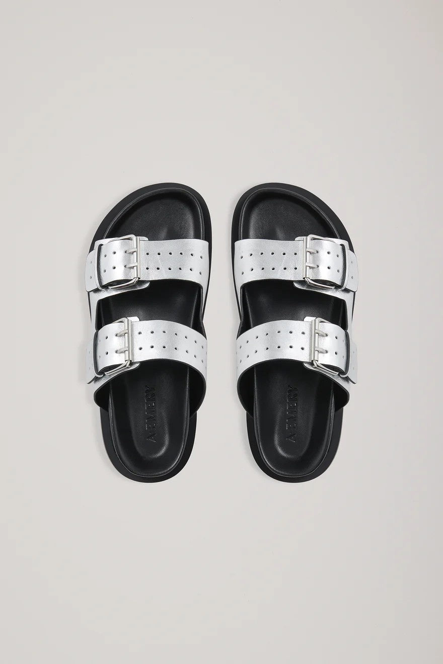 Silver slides with silver buckles on a light gray background
