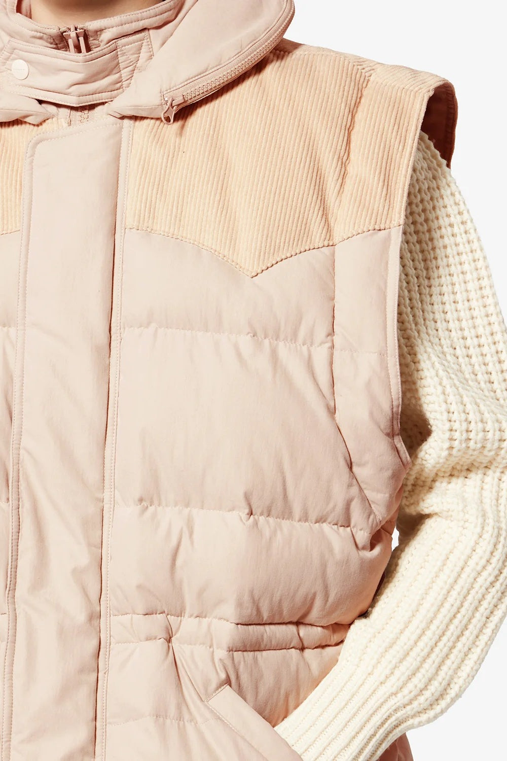 Beige quilted vest with a textured collar and cuffs on a neutral background