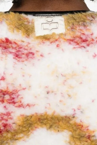 Close-up of a textured surface with a brand logo in the center.