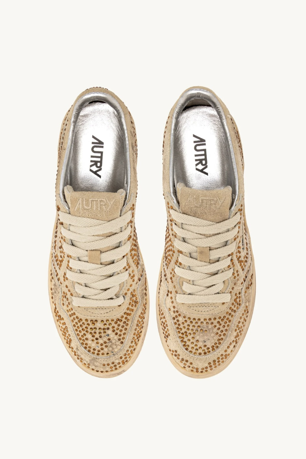 Pair of bronze Autry Bloom sneakers with rhinestones on a white background