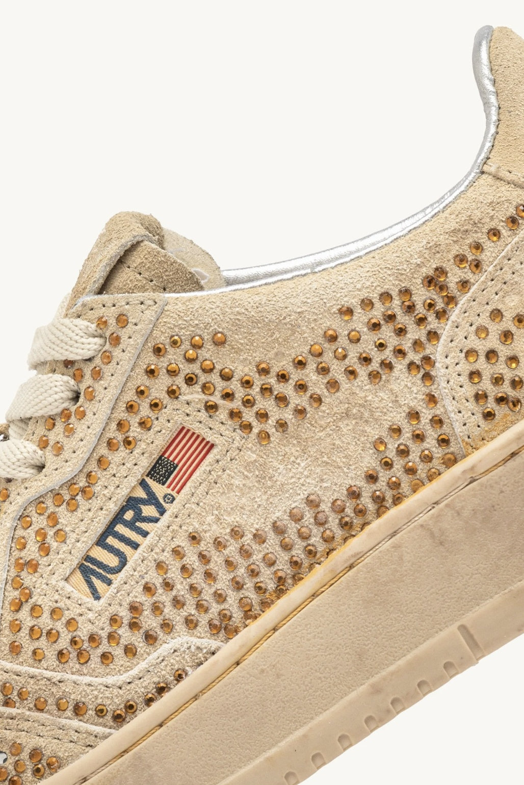 Bronze Autry Bloom sneaker with rhinestone studs and Autry branding on a white background