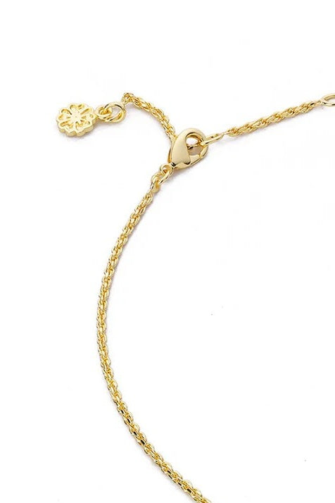 Gold necklace clasp detail on a white background