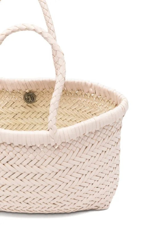 Woven basket with a handle on a white background