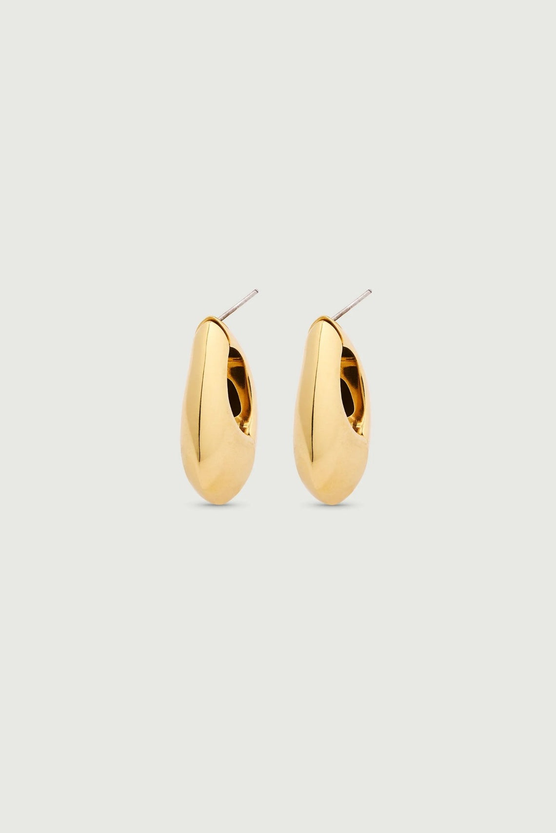 Gold hoop earrings on a light gray background