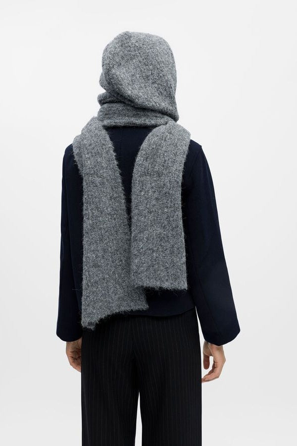 Person wearing a gray hooded scarf on a white background