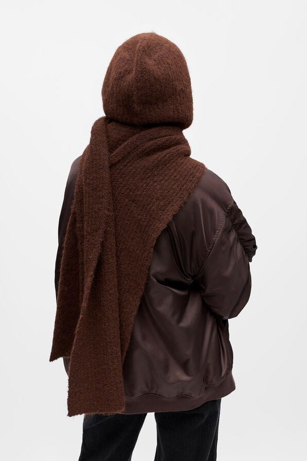 Person wearing a brown hooded scarf on a white background