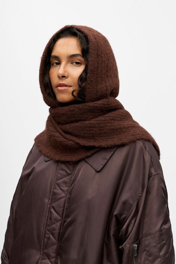 Person wearing a brown hooded scarf on a white background