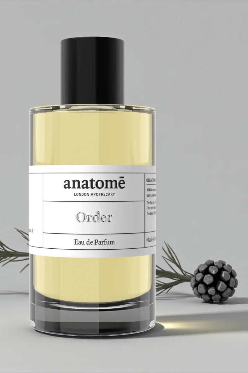 Anatomé perfume bottle with a label on a gray background