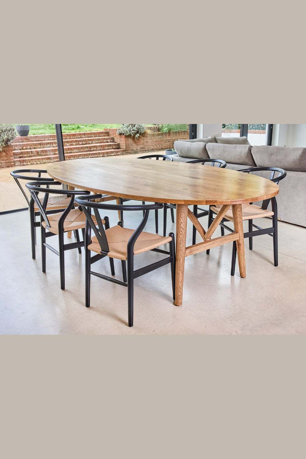 Wooden dining table with chairs in a modern living room setting