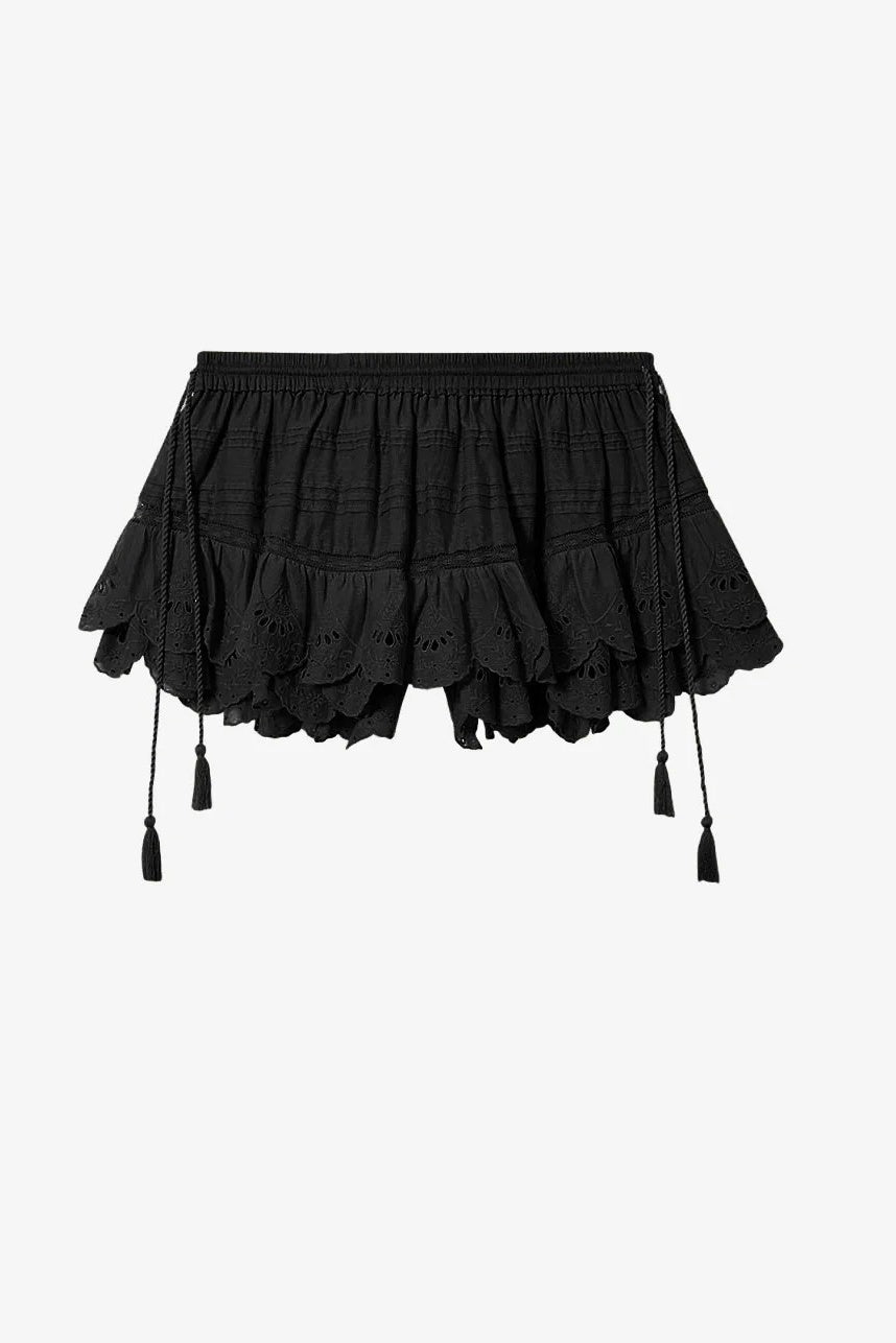 Black ruffled shorts with tassels on a white background