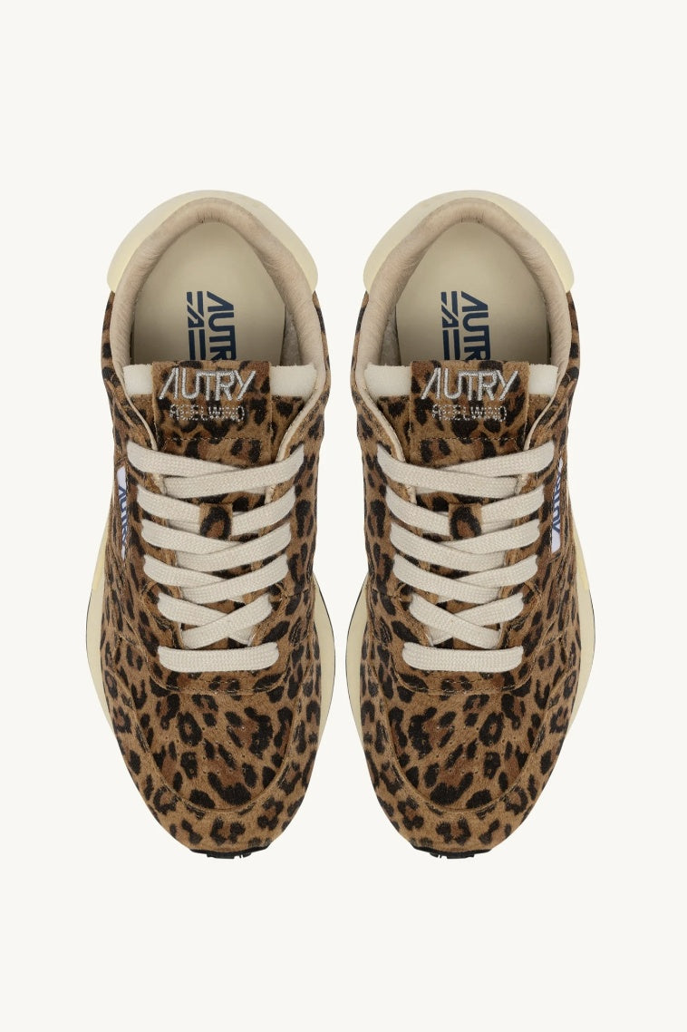pair of leopard trainers  with cream laces and autry branding on tounges on white background.