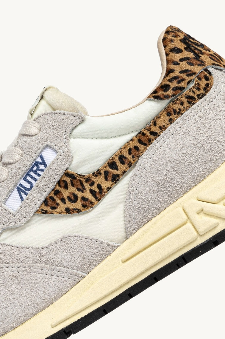 Close up of grey and leopard print trainer view from the side