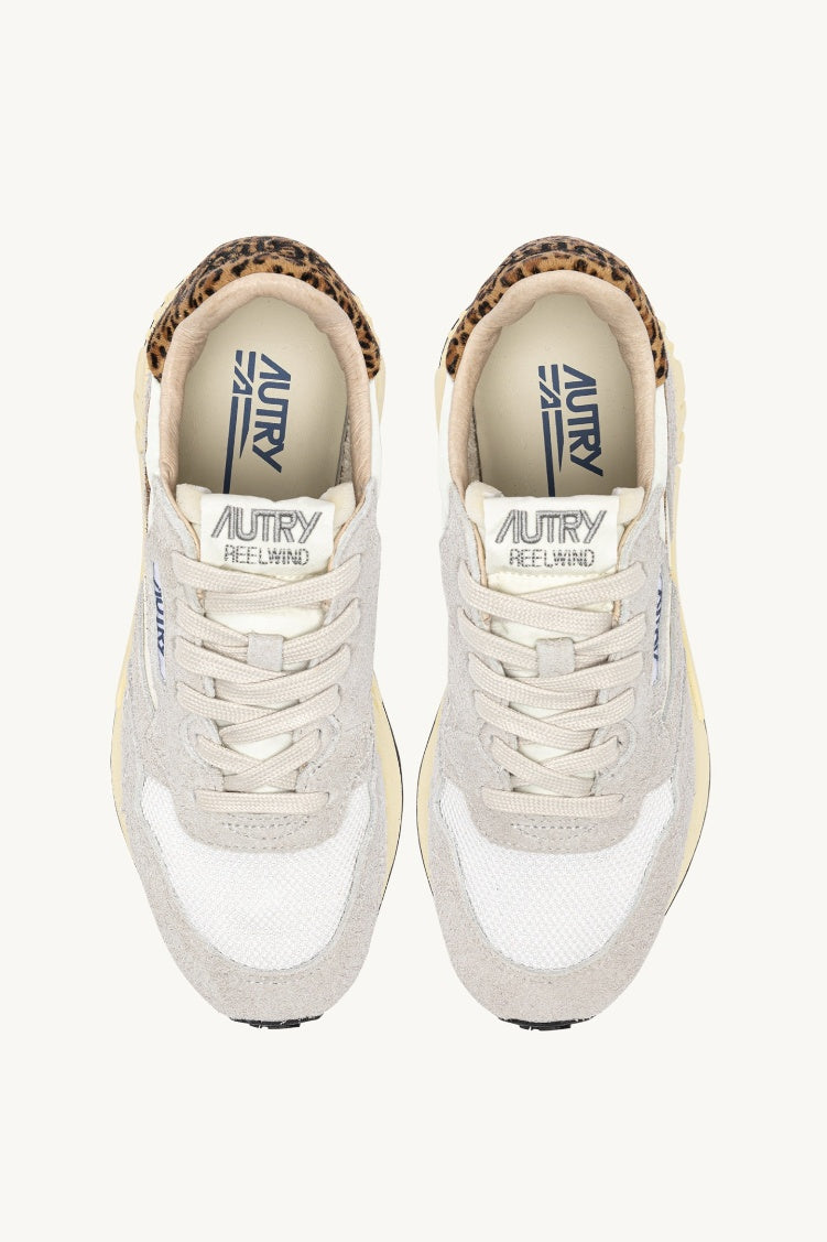 A pair of grey and leopard print trainers view from above