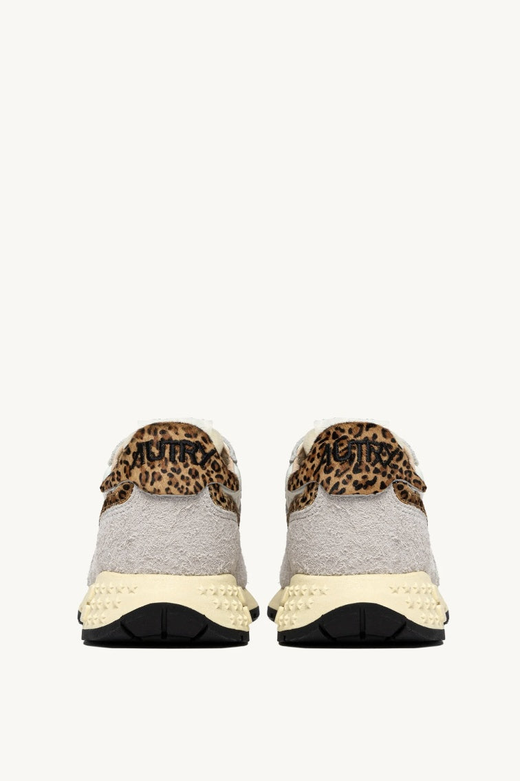 A pair of grey and leopard print trainers view from the back