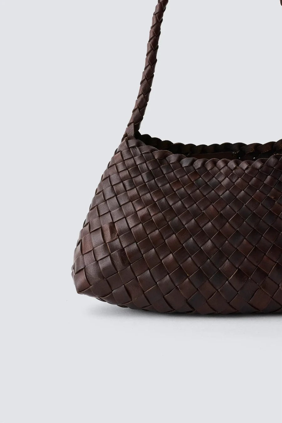 Brown woven handbag on a light gray background